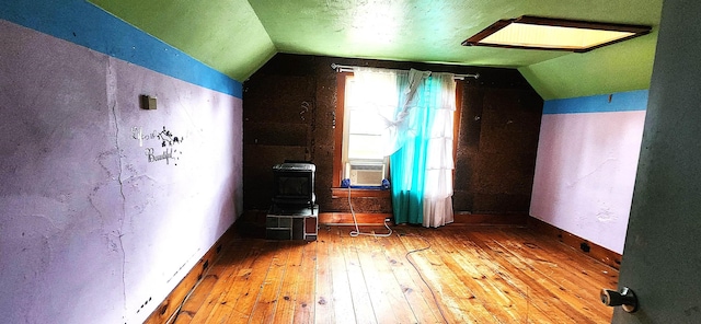 bonus room with lofted ceiling, wood-type flooring, cooling unit, and a textured ceiling