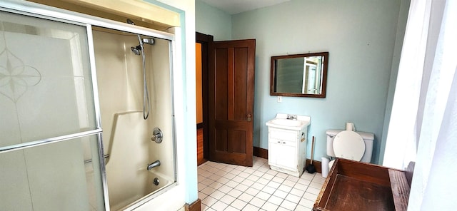 full bathroom featuring toilet, tile patterned flooring, combined bath / shower with glass door, and vanity