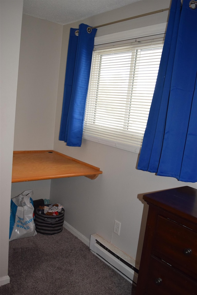 unfurnished bedroom with a baseboard radiator, carpet flooring, and baseboards