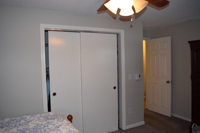 bedroom with ceiling fan, a closet, carpet flooring, and baseboards