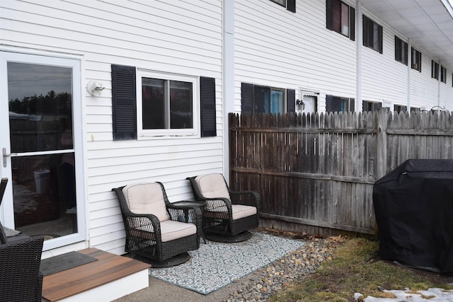 view of patio with grilling area and fence