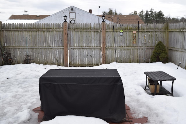 yard covered in snow with fence