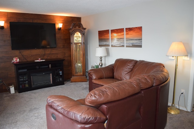 living room featuring wood walls, carpet, and a fireplace