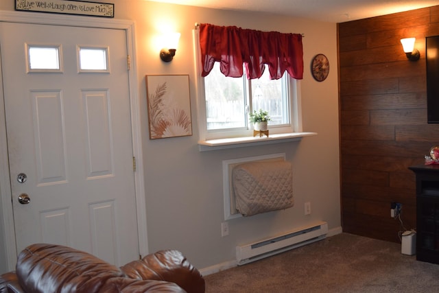 living room featuring dark colored carpet, baseboard heating, and wooden walls