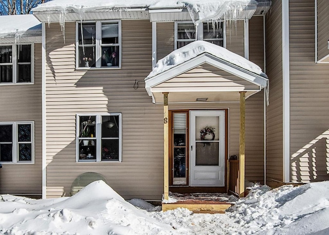 view of snow covered property entrance