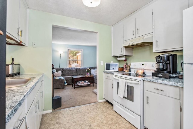 kitchen featuring light carpet, white appliances, white cabinets, light countertops, and under cabinet range hood