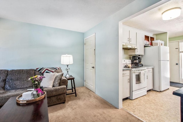 kitchen featuring light carpet, white appliances, open floor plan, under cabinet range hood, and white cabinetry