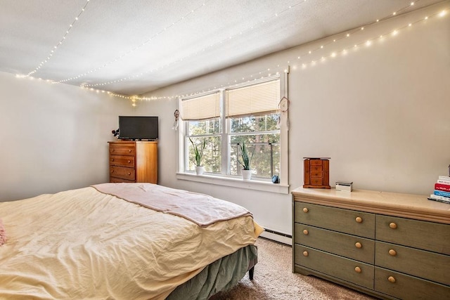 carpeted bedroom with a baseboard radiator