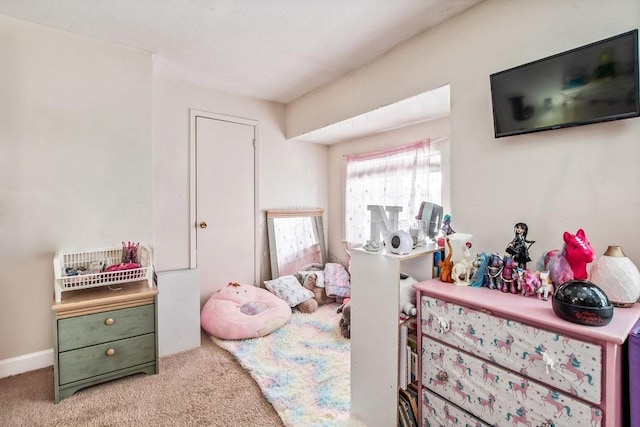 bedroom featuring carpet and baseboards