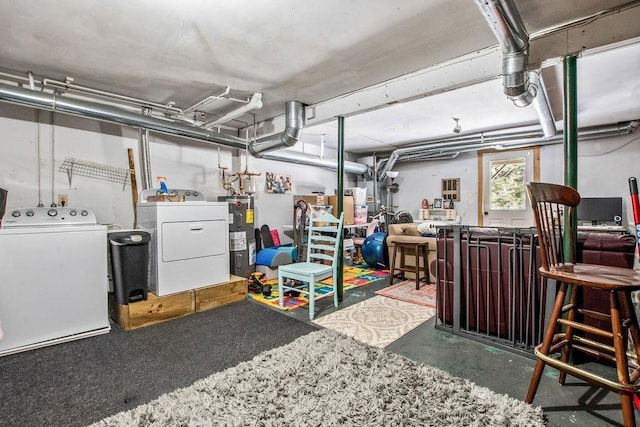 basement featuring electric water heater and washing machine and clothes dryer