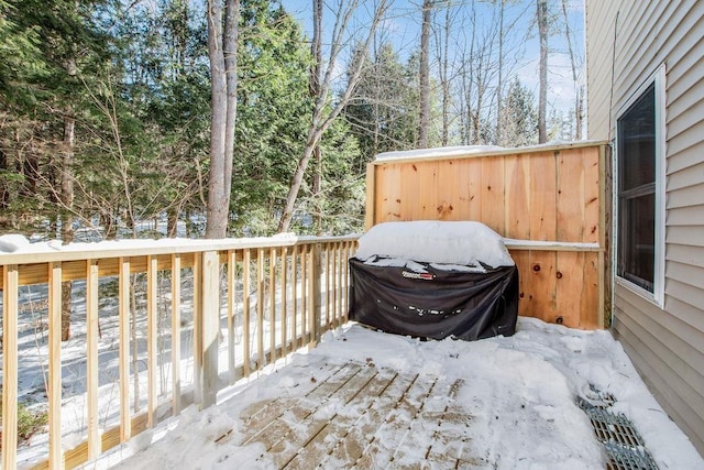 snow covered deck featuring a grill