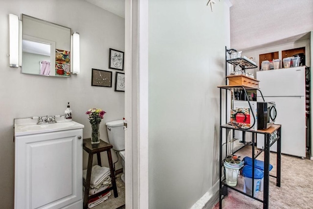 interior space featuring vanity and toilet