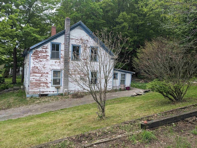 238/266 S Main St, Danby, VT 05739 - view of side of home featuring a chimney and a yard