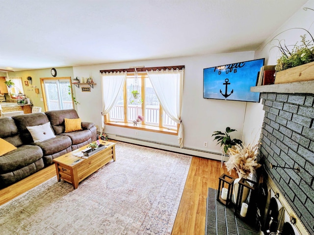 living area with a baseboard heating unit and wood finished floors