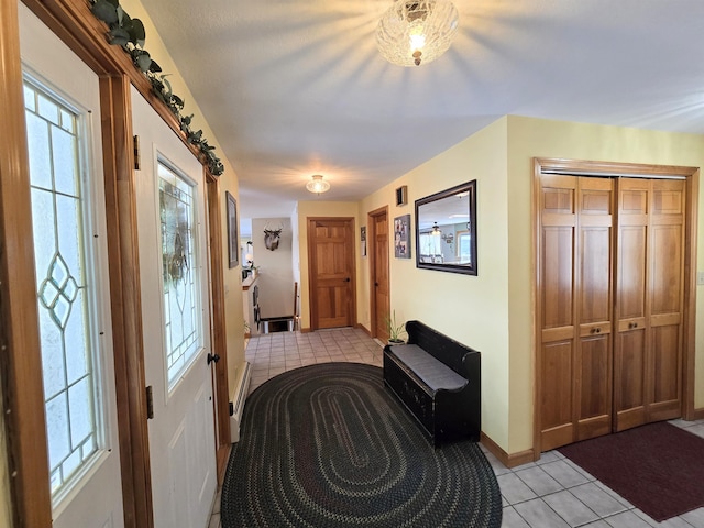 entrance foyer featuring light tile patterned flooring and baseboards