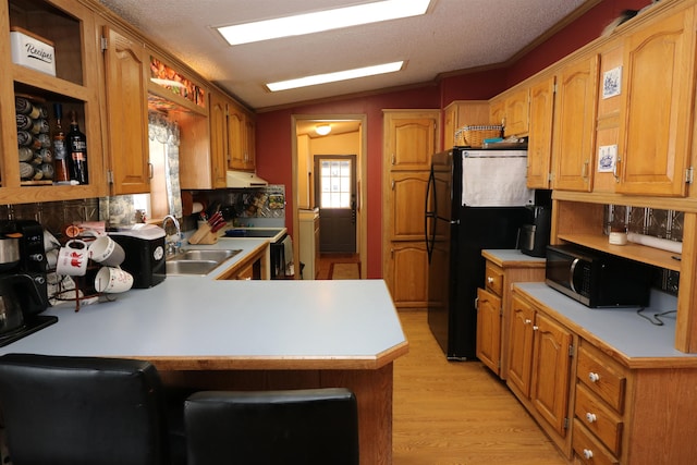 566 Baptist St, Williamstown, VT 05679 - kitchen with lofted ceiling, a peninsula, light countertops, black appliances, and light wood finished floors