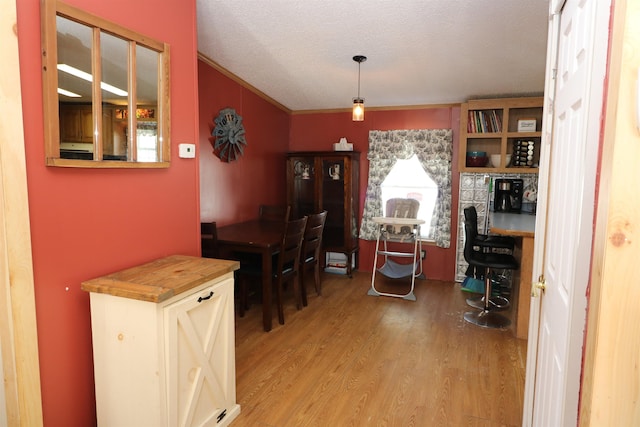 566 Baptist St, Williamstown, VT 05679 - dining area featuring light wood-type flooring, a textured ceiling, and crown molding