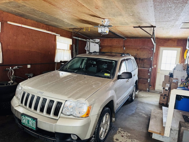 garage featuring wood walls and a garage door opener