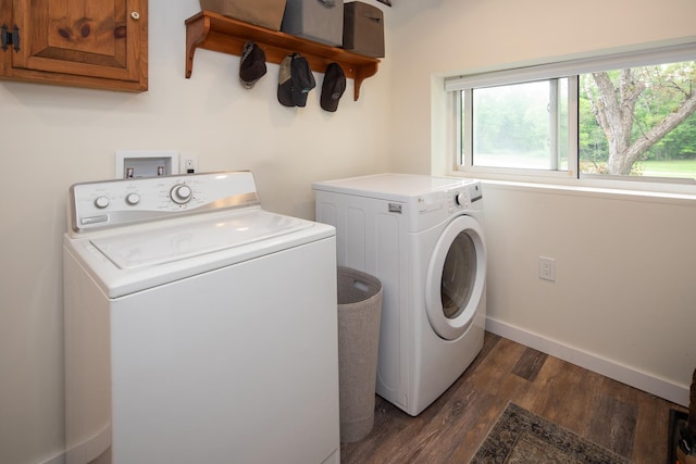 laundry area featuring washer and clothes dryer, dark wood-style floors, cabinet space, and baseboards