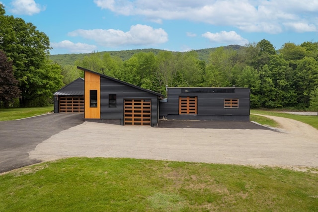 view of outbuilding featuring an outdoor structure and a view of trees