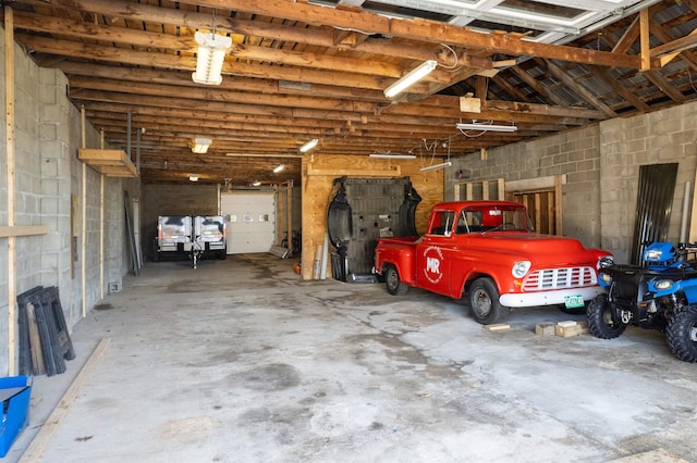 garage with concrete block wall