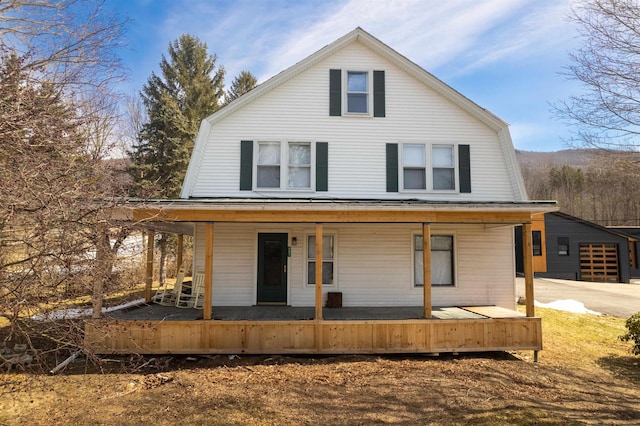 view of front of house with a gambrel roof and covered porch