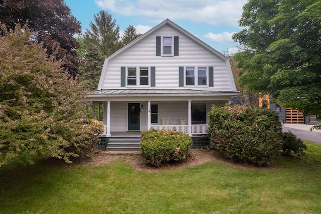 dutch colonial with a gambrel roof, a front lawn, a standing seam roof, covered porch, and metal roof