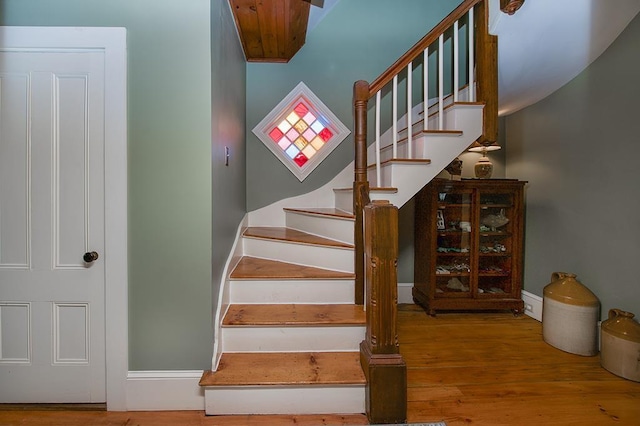 stairway featuring baseboards and wood finished floors