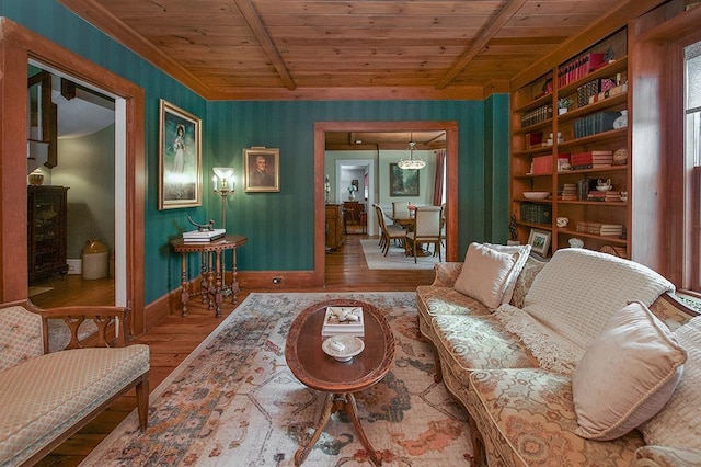 living room with wooden ceiling, baseboards, wood finished floors, and beamed ceiling