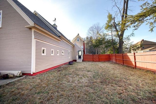 view of yard featuring entry steps and fence private yard