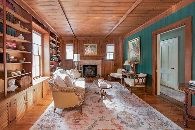 living area with wooden ceiling, built in features, hardwood / wood-style flooring, and wooden walls