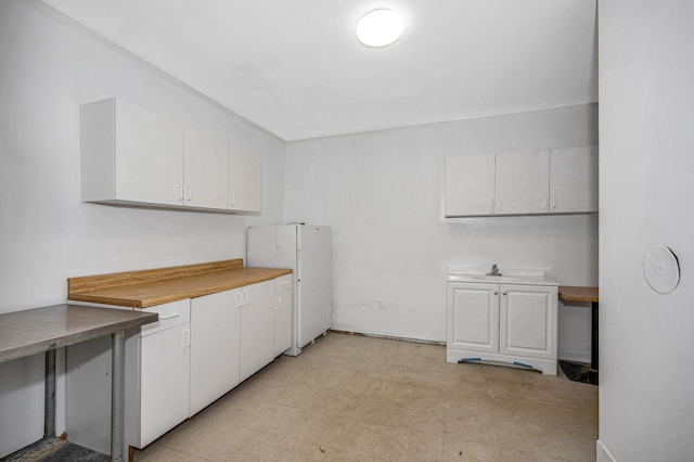 kitchen featuring white cabinets and light floors