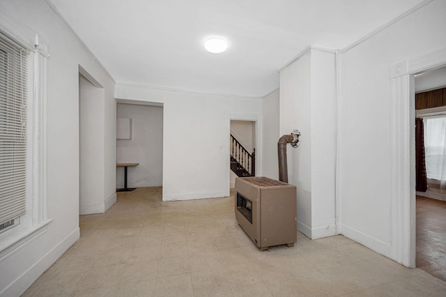 hall with light floors, stairway, and baseboards