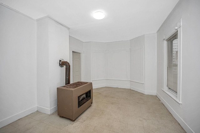 interior space featuring a wood stove and baseboards