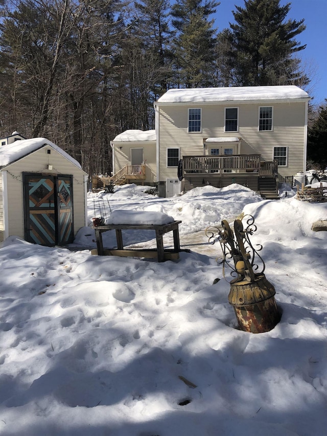 exterior space with an outbuilding, a deck, and a storage unit