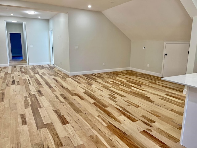 bonus room with lofted ceiling, light wood-style flooring, baseboards, and recessed lighting