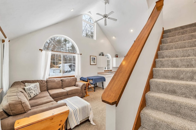 carpeted living room with high vaulted ceiling, recessed lighting, stairway, and a ceiling fan