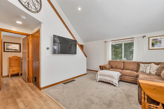 living area with recessed lighting, visible vents, baseboards, vaulted ceiling, and light wood finished floors