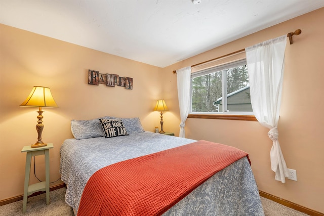 bedroom with carpet floors and baseboards