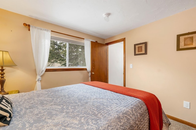 bedroom featuring carpet and baseboards