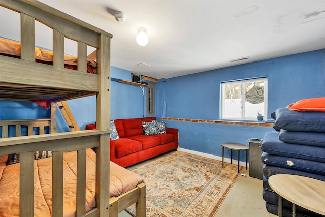 living room featuring concrete floors, visible vents, and baseboards