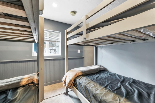 bedroom featuring wainscoting