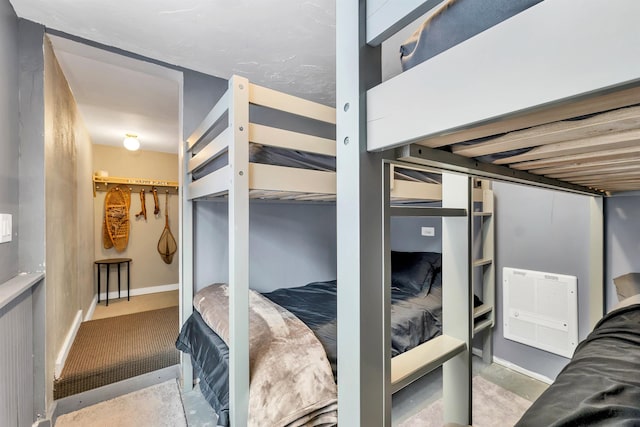 bedroom with multiple closets and concrete floors