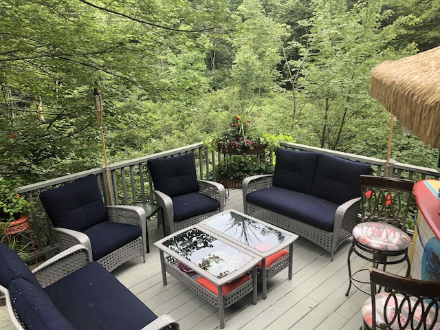 wooden terrace with a forest view and outdoor lounge area