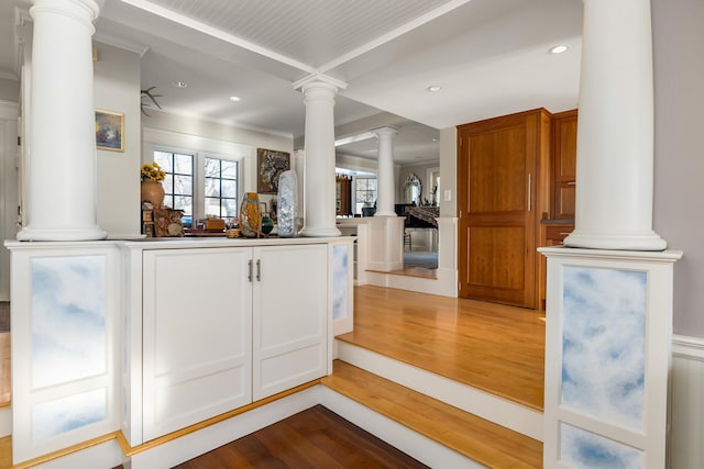 bar with decorative columns, crown molding, wood finished floors, and recessed lighting