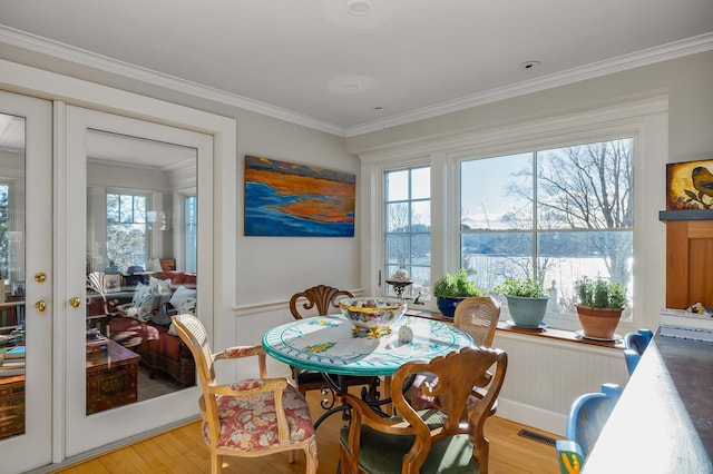 dining area featuring french doors, ornamental molding, and a wealth of natural light