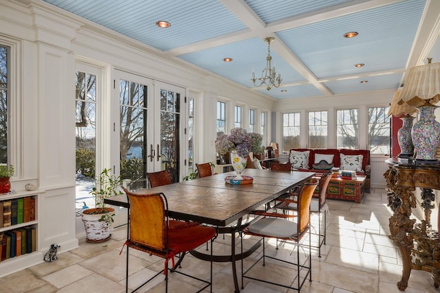 sunroom with french doors, coffered ceiling, beam ceiling, and an inviting chandelier