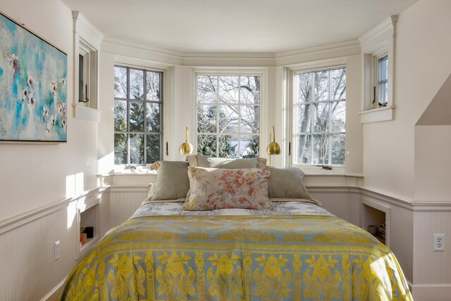 bedroom featuring wainscoting