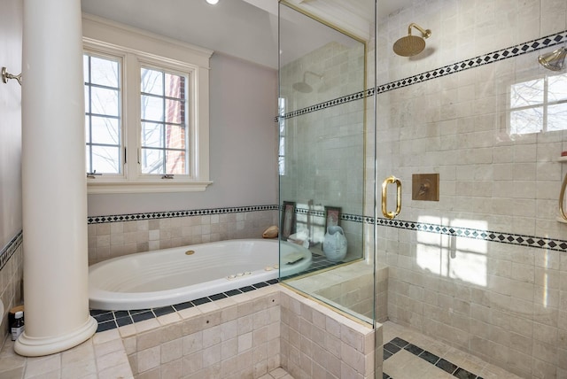 bathroom featuring a garden tub, a shower stall, and ornate columns