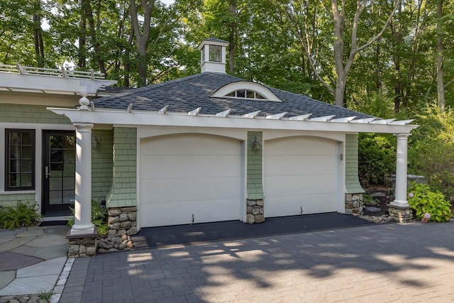 garage with decorative driveway